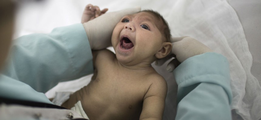 An infant in Brazil born with microcephaly is examined by a neurologist. The Zika virus is thought to cause microcephaly. 