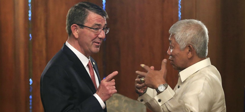 Defense Secretary Ash Carter speaks with his Philippine counterpart, Voltaire Gazmin, on Thursday.  