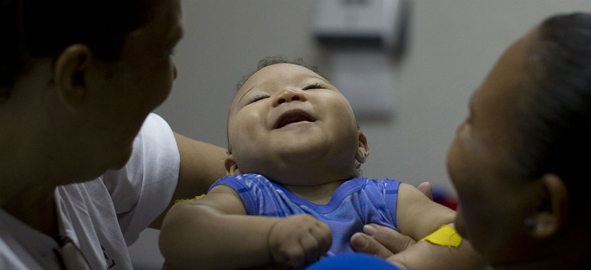 A baby with microcephaly in Brazil goes to physical therapy. 