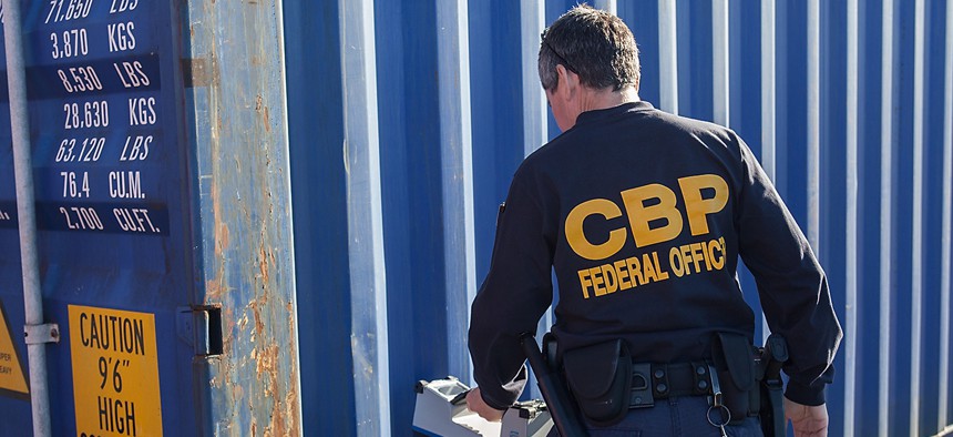A CBP officer examines a shipping container at the Port of Newark in 2012.