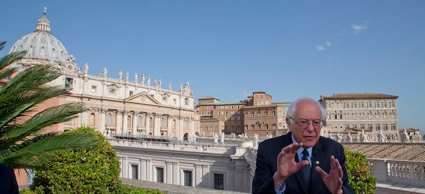 Backdropped by St. Peter's Basilica, Bernie Sanders speaks in Vatican City Saturday.