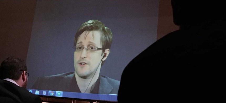 Edward Snowden speaks via video conference to people in the Johns Hopkins University auditorium in February.