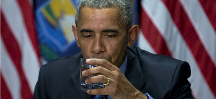 President Obama takes a sip of filtered water during a press conference in Flint on Wednesday. 