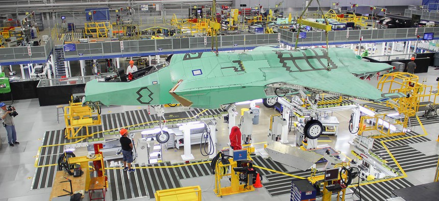 Norway's first F-35 is lifted by an overhead crane in Lockheed Martin's assembly plant in Fort Worth in April 2015.