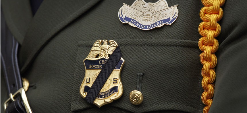 A U.S. Border Patrol Agent wears a black stripe over his badge during the 22nd Annual Blue Mass ceremony kicking off National Police Week at St. Patrick's Catholic Church in Washington, May 3.