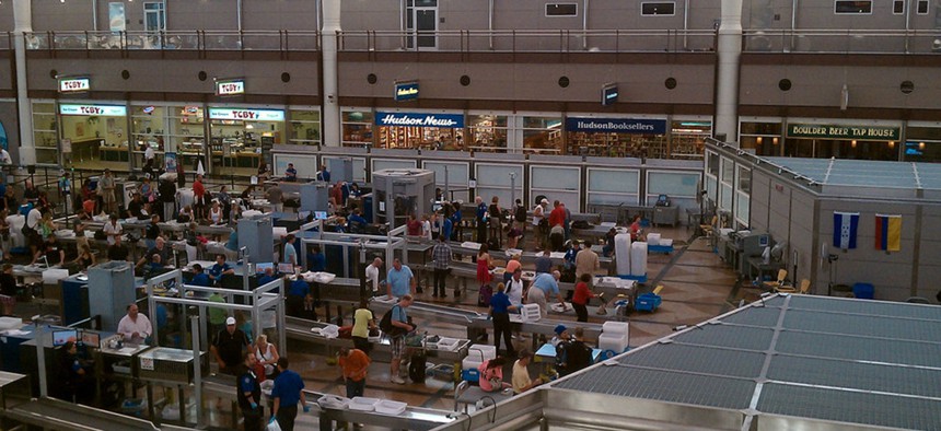 Passengers go through security at Denver International Airport in 2010.