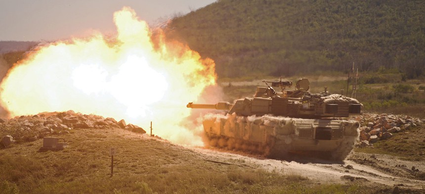 A burst of fire erupts from the muzzle of a 2nd Armored Brigade Combat Team in a training exercise in 2014.