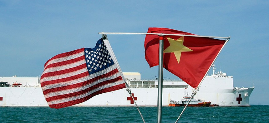 U.S. and Vietnamese flags fly in unison as the Military Sealift Command hospital ship USNS Mercy (T-AH 19) sits on station in the Gulf of Tonkin, July 13, 2012.