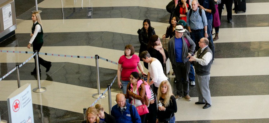 Passengers wait in a screening line at Chicago's O'Hare International Airport. 