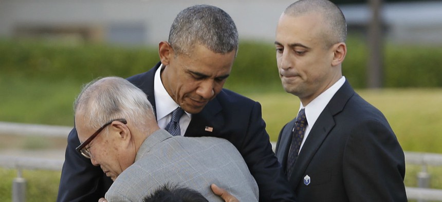 Obama hugs Shigeaki Mori, an atomic bomb survivor and a creator of the memorial for American WWII POWs killed in Hiroshima. 