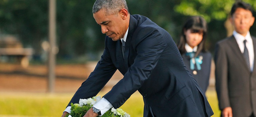 Obama lays wreaths at the cenotaph at Hiroshima Peace Memorial Park Friday.