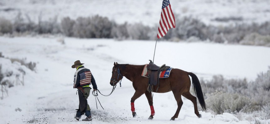 A supporter of the group occupying the Malheur National Wildlife Refuge earlier this year walks his horse near Burns, Ore. Attacks were on the rise even before the occupation. 