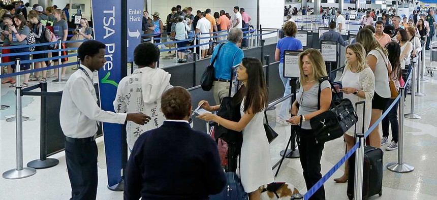 Travelers stand in line as they prepare to be screened at a Transportation Security Administration checkpoint at Fort Lauderdale-Hollywood International Airport, Friday, May 27, 2016, in Fort Lauderdale, Fla. Memorial Day week.