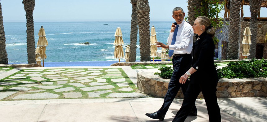 Clinton and Obama walk together after a 2012 meeting in Mexico.