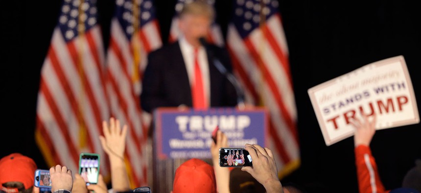 People in the audience use mobile phones to record Donald Trump as he speaks at a Rhode Island rally in April.