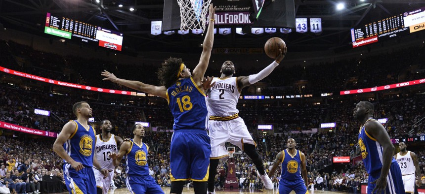 Cleveland Cavaliers guard Kyrie Irving (2) drives against Golden State Warriors forward Anderson Varejao (18) during the second half of Game 3 of basketball's NBA Finals in Cleveland June 9.