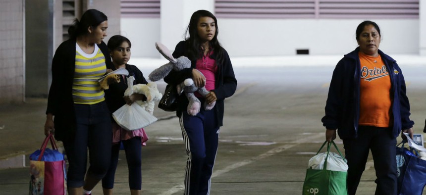 Immigrants from El Salvador and Guatemala head to a bus after being released from a family detention center in San Antonio, Texas. 