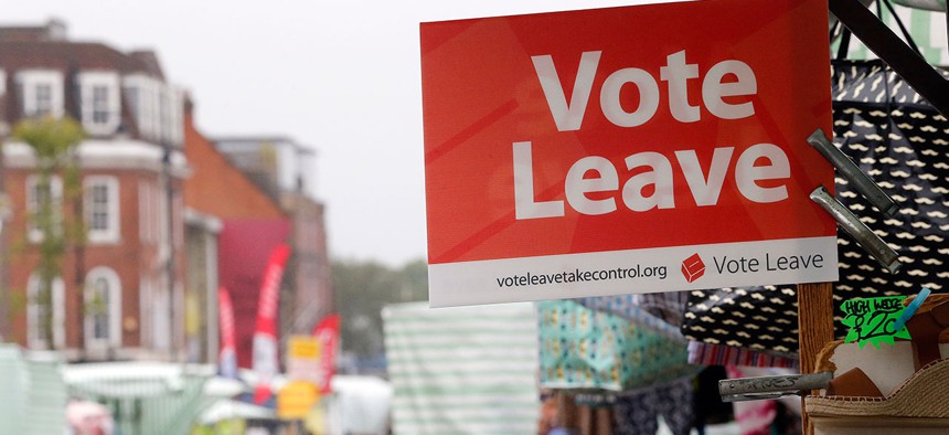 A Vote Leave sign is fixed on a market stall at Havering's Romford street market in London
