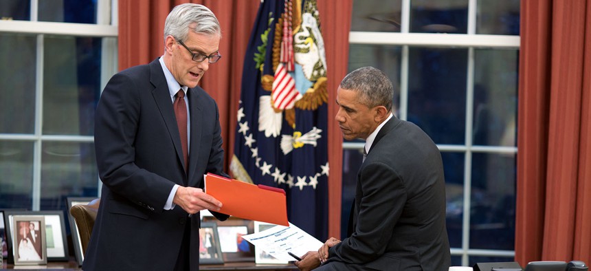 Barack Obama confers with Chief of Staff Denis McDonough in the Oval Office  in 2015.