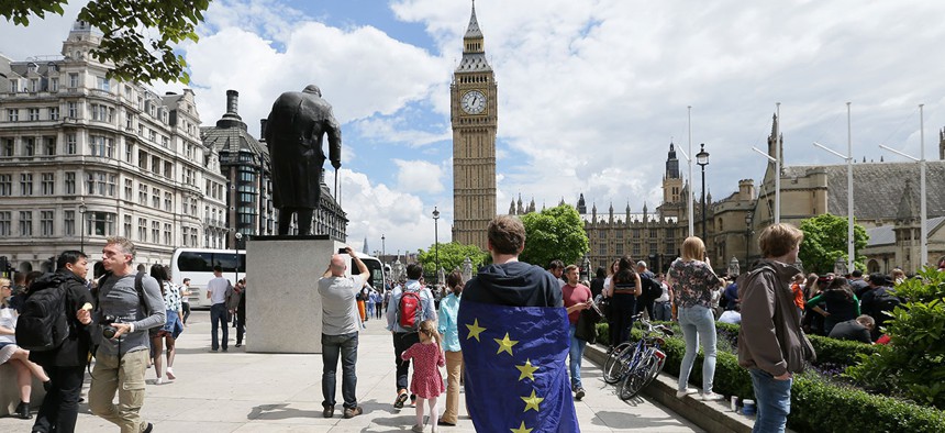A demonstrator wrapped in the EU flag takes part in a protest opposing Britain's exit from the European Union in Parliament Square last week.