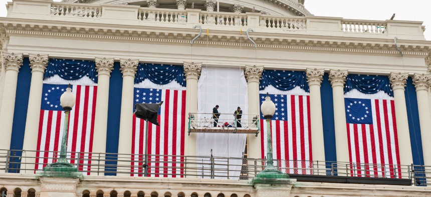 Government employees hang bunting at the U.S. Capitol before the 2009 inauguration.