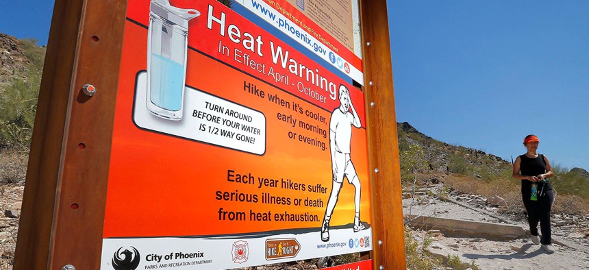 A sign at Piestewa Peak in Phoenix warns hikers of heat exposure in June.