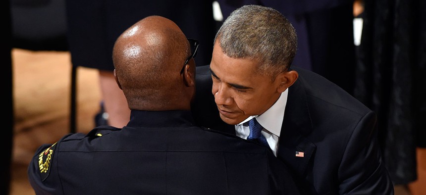 President Barack Obama hugs Dallas Police Chief David Brown after Brown introduced Obama to speak at an interfaith memorial service for the fallen police officers and members of the Dallas community.