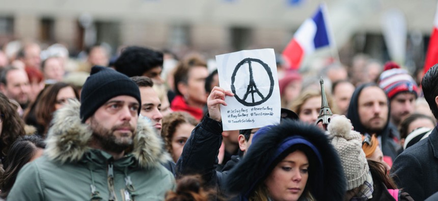 Crowds gather at Toronto's Nathan Phillips Square for a silent vigil for the 2015 Paris attacks.