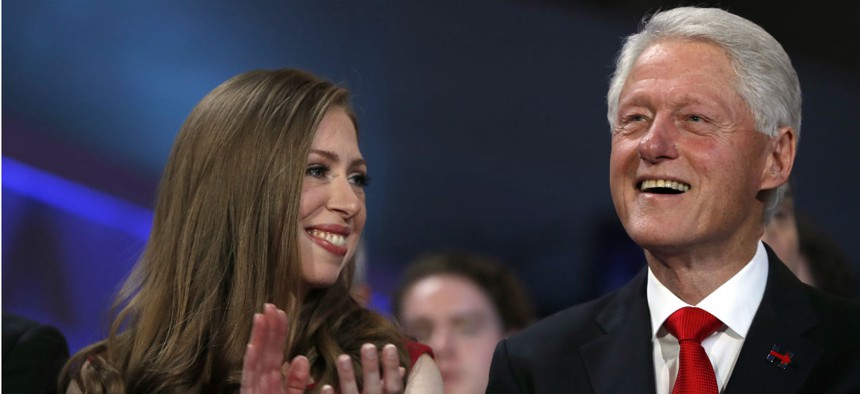 Chelsea Clinton and former President Bill Clinton listen to Hillary Clinton's speech at the Democratic National Convention. 