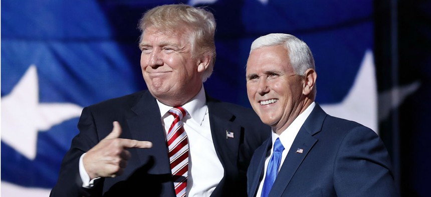 Republican presidential nominee Donald Trump (left) joins vice presidential nominee Mike Pence after Pence's acceptance speech. 