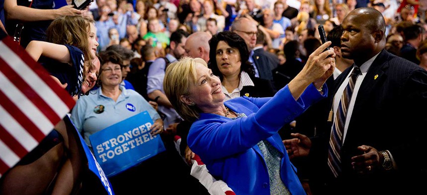 Democratic presidential candidate Hillary Clinton takes a selfie with supporters in New Hampshire in July.