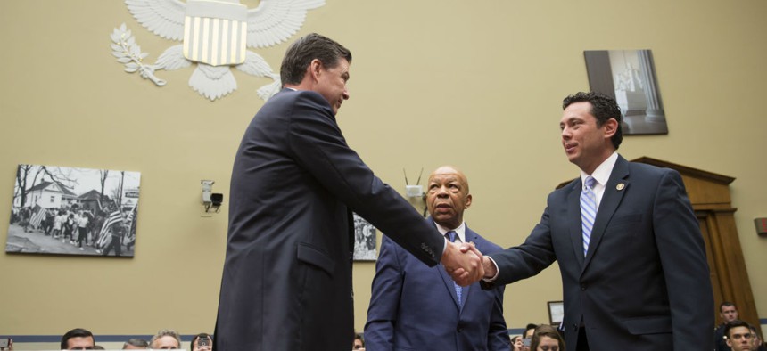 House Oversight committee chairman Rep. Jason Chaffetz, R-Utah, right, and ranking member Rep. Elijah Cummings, D-Md., center, welcome FBI Director James Comey on July 7.
