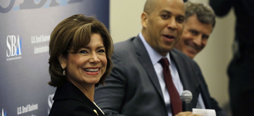 SBA Administrator Maria Contreras-Sweet listens to audience questions during an event with Sen. Cory Booker and Princeton University Professor Alan B. Krueger, right, at the Rutgers Business School in 2015.