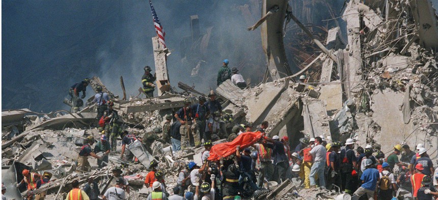 Emergency personnel carry an orange body bag with the remains of a victim, two days after the terrorist attacks on the World Trade Center in New York on Sept. 11, 2001.