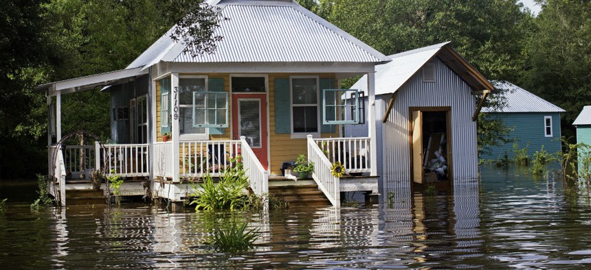 Floodwaters reach the front steps of a home near Holden, Louisiana.