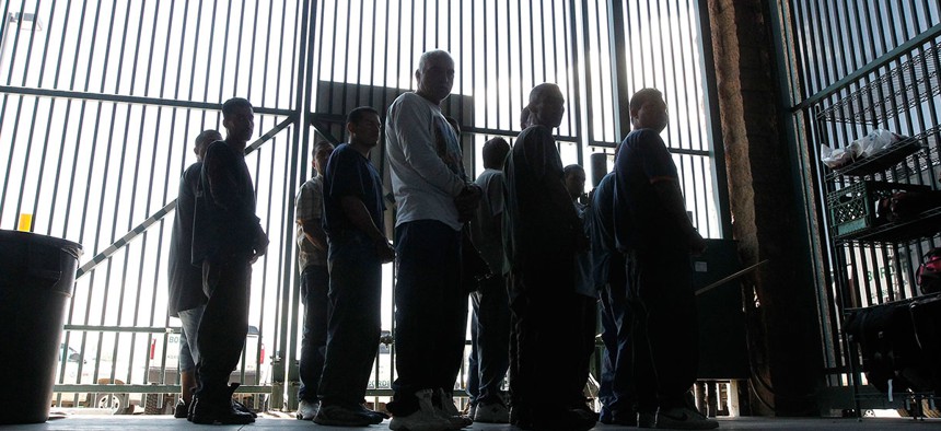 Persons are detained for being in the country illegally and are transferred out of the holding area after being processed at the Tucson Sector of the U.S. Customs and Border Protection headquarters in Tucson, Ariz. in 2012.