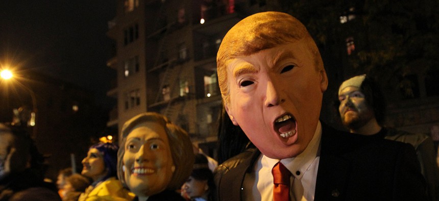 Halloween revelers wear Clinton and Trump masks in New York in 2015.
