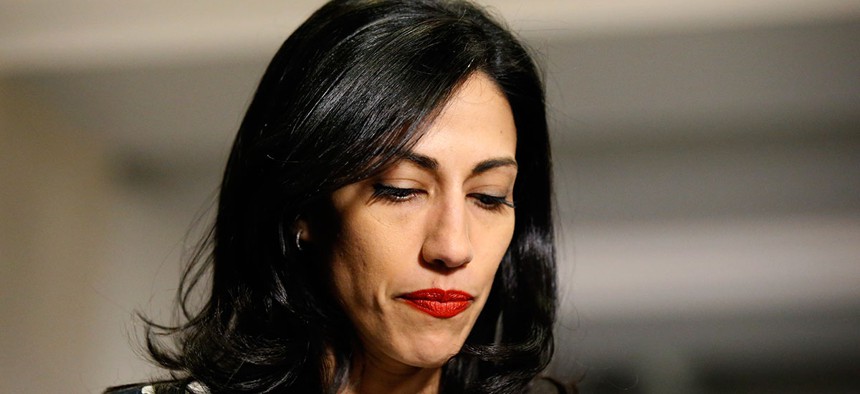 Huma Abedin pauses while speaking to the media after testifying at a closed-door hearing of the House Benghazi Committee in 2015.
