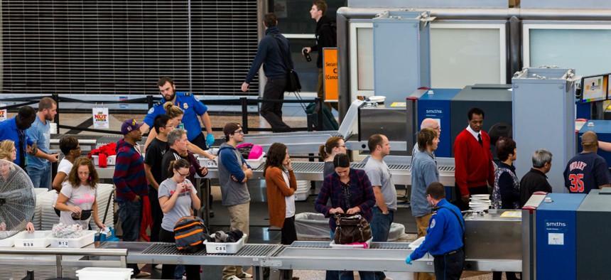 TSA officers inspect luggage at Denver International Airport. 