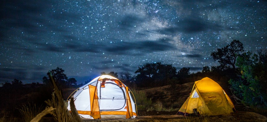 People camp in tens under the Milky Way's light in Canyonlands National Park in 2011.