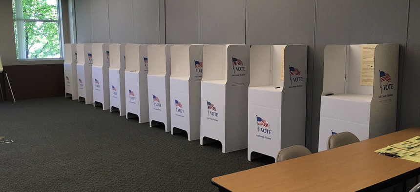 Voting booths are prepared in anticipation of Idaho's May primary in Boise.