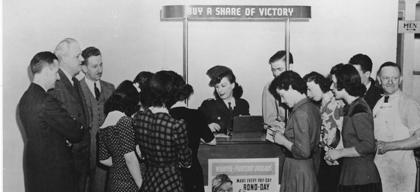 A young woman sells war bonds during World War II. Unlike today's conflicts, previous wars were largely pay-as-you-go affairs.