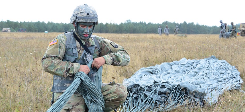A U.S. Paratrooper recovers a parachute after airborne operation at 7th Army Training Command’s Grafenwoehr Training Area, Germany on Sept. 9.