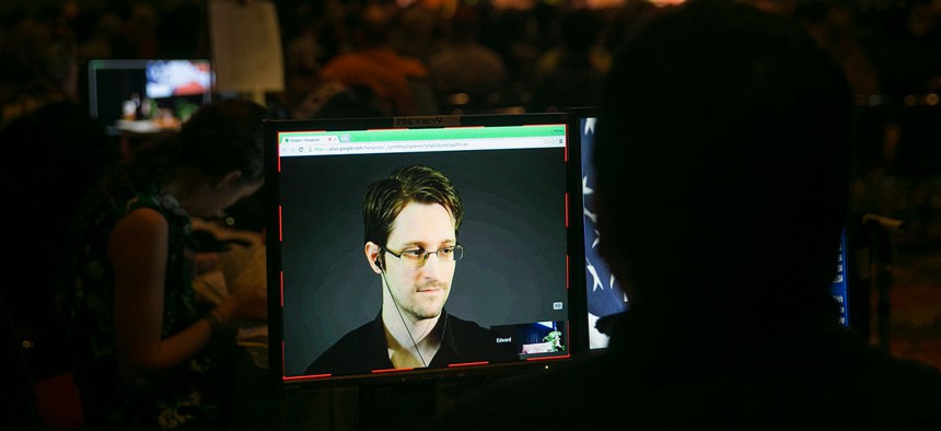 A video technician monitors a computer screen as National Security Agency leaker Edward Snowden appears on a live video feed broadcast from Moscow to Hawaii in 2015.