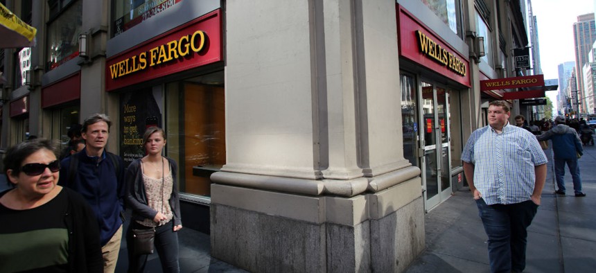 Pedestrians walk past a Wells Fargo branch in Manhattan in 2013. 