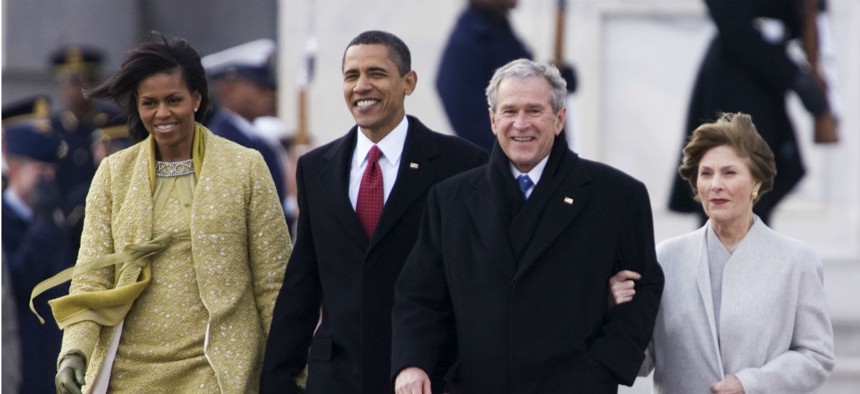 President Barack Obama and first lady Michelle Obama walk with former President George W. Bush and former first lady Laura Bush, as they leave the Capitol after the swearing-in ceremony Tuesday, Jan. 16, 2009.