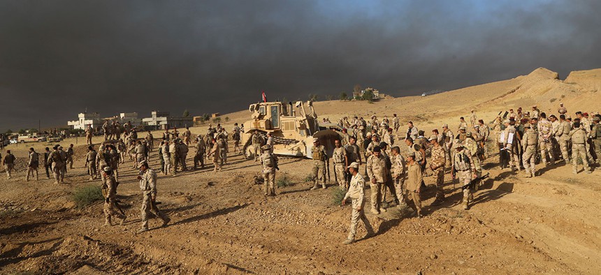 Iraqi army soldiers wait for an attack to begin against the Islamic State group of Mosul on Thursday.