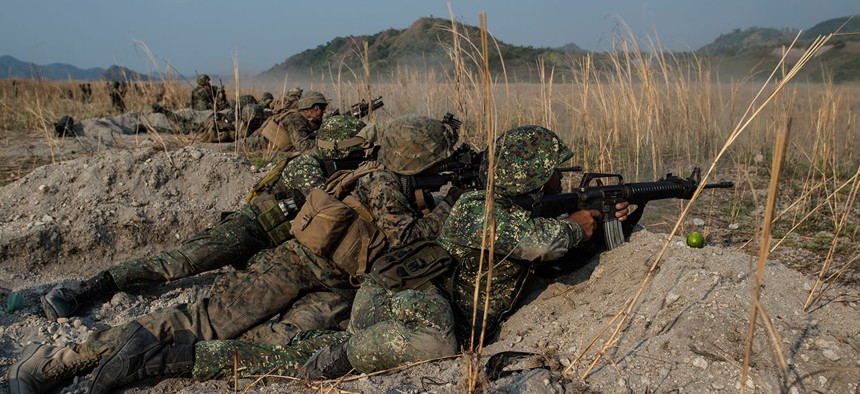 U.S. and Philippine Marines fire their rifles “shoulder-to-shoulder” during Balikatan 16, at Crow Valley, Philippines in April.