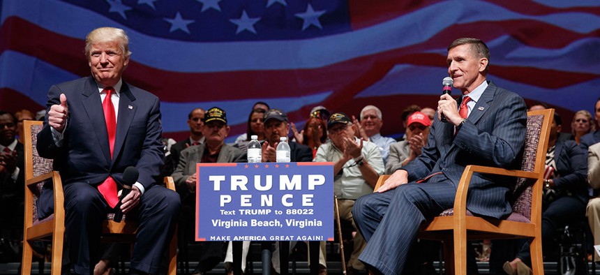 Republican presidential candidate Donald Trump gives a thumbs up as he speaks with retired Lt. Gen. Michael Flynn during a town hall in September.