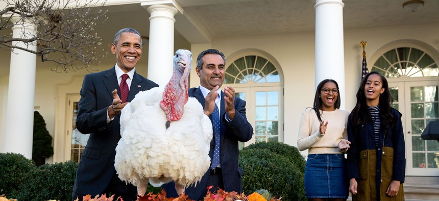 President Barack Obama and his daughters Sasha and Malia participate in the annual National Thanksgiving Turkey pardon ceremony in the Rose Garden with National Turkey Federation Chairman Jihad Douglas in 2015.